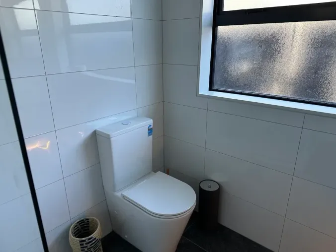 Completed blue-grey bathroom renovation with freestanding bath